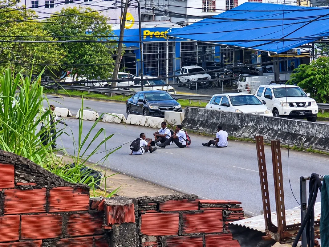Schoolchildren filmed taking dangerous pictures while sitting on busy roadway