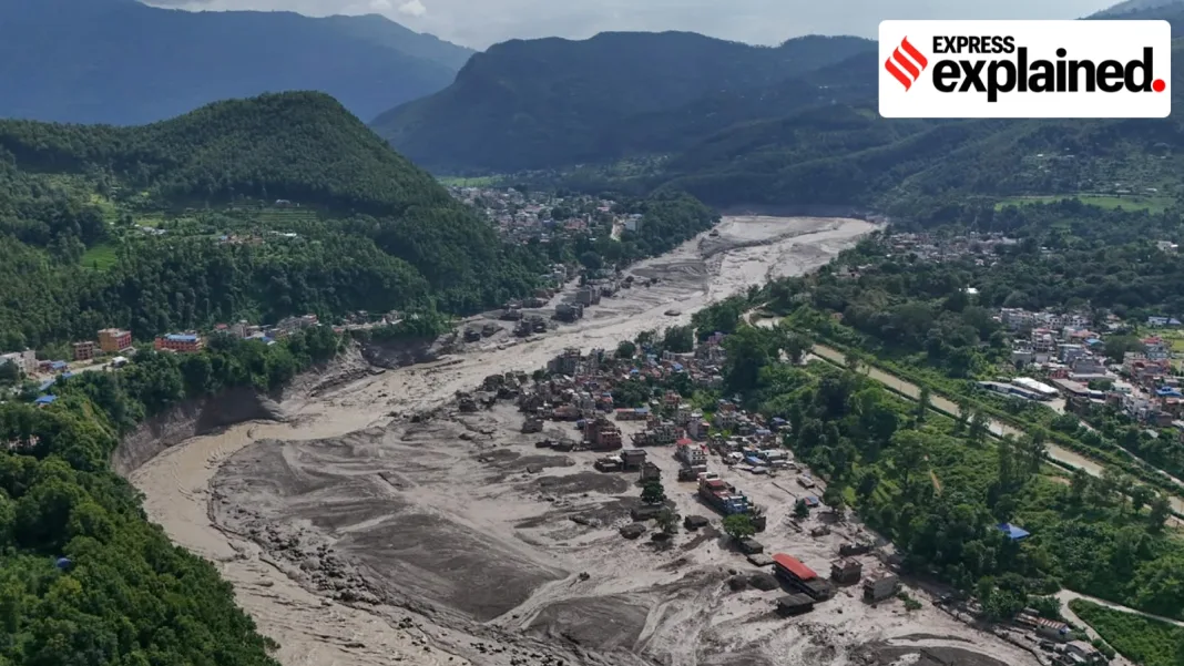 Damaged houses stand precariously near the swollen, debris-choked banks of the Trishuli River after flash floods in Nepal's Nuwakot district on Wednesday, Aug. 26, 2026. (AP Photo/Niranjan Shrestha)