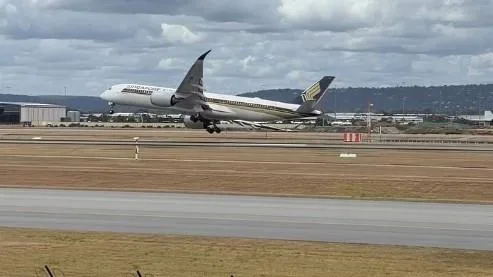 Dramatic footage has captured the moment a passenger plane was forced to abandon its landing at Perth Airport in a scary near-miss.