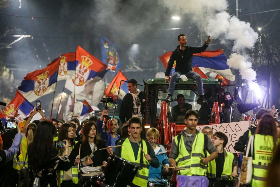 BELGRADE, SERBIA - MARCH 14: Demonstrators wave Serbian flags as they gather behind barricades in Belgrade, Serbia, on March 14, 2025, ahead of a large protest against the government. The demonstration comes in response to last year's train station collapse, which claimed 15 lives. Participants from various cities arrived by walking, running, or cycling, receiving applause upon their arrival. Filip Stevanovic / Anadolu/ABACAPRESS.COM
